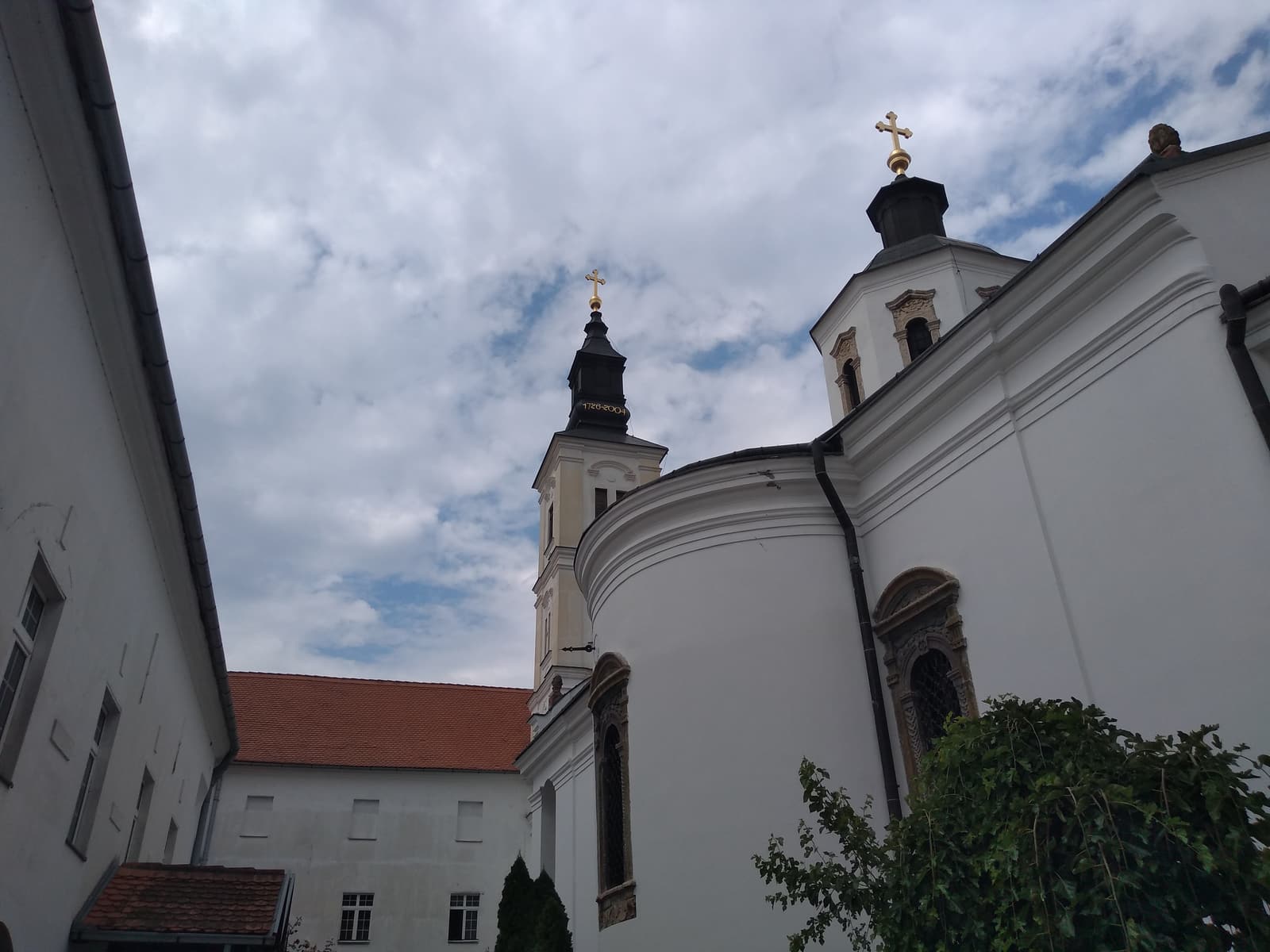 The church of Krušedol Monastery with its baroque bell tower, seen from the courtyard