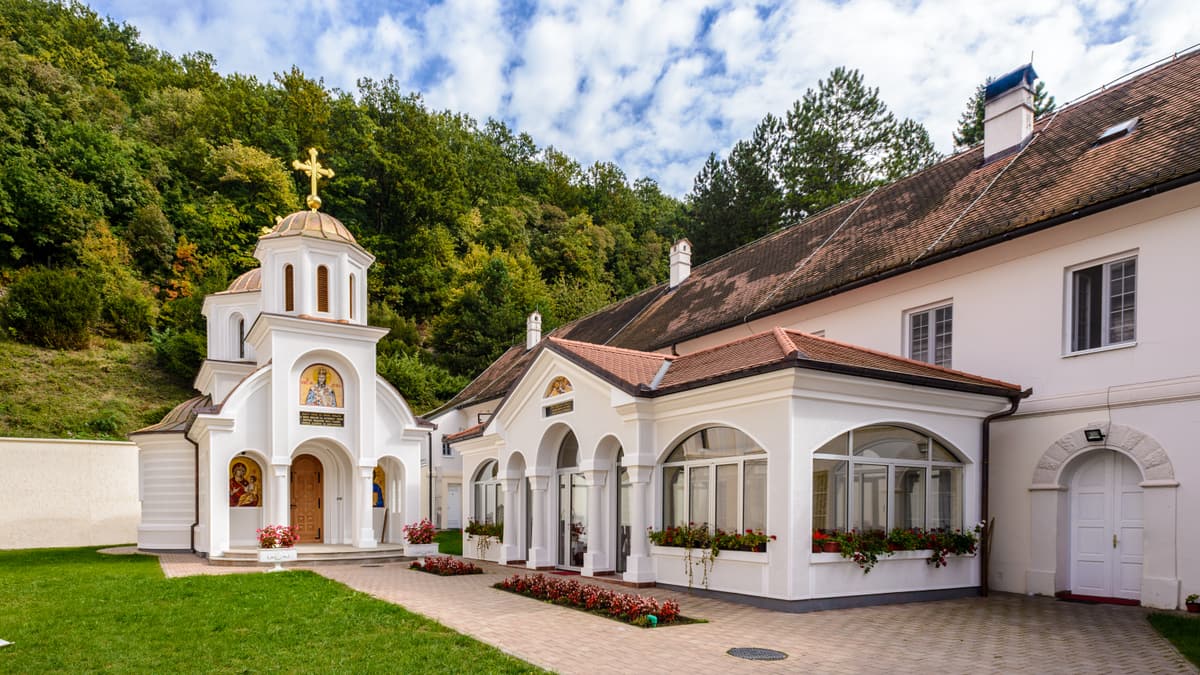 The chapel and residence of Beočin Monastery at the foot of a wooded slope